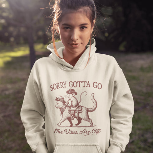 Take your fashion game to the wild frontier with our quirky and bold hoodie featuring a mouse riding a cat like a cowboy—both decked out in classic cowboy hats.
